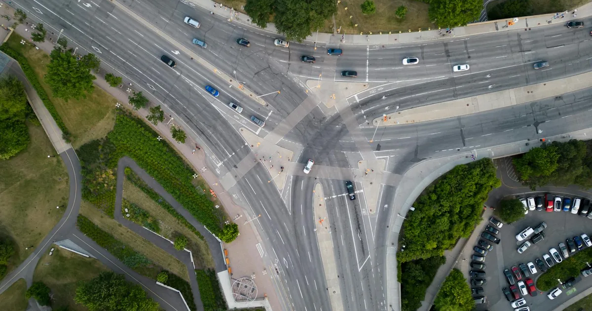 Aerial view of a busy intersection with multiple lanes and parked.