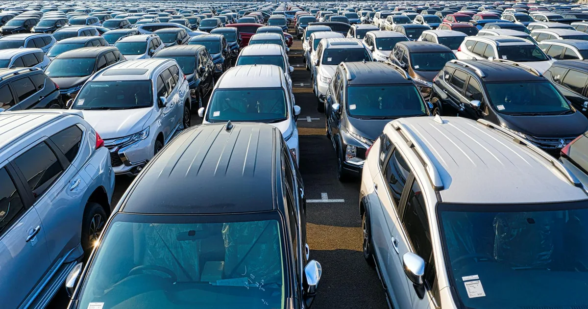 Aerial view of a crowded parking lot filled with various parked.