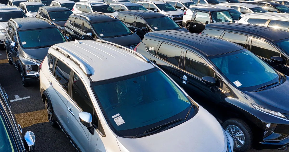 Aerial view of a crowded parking lot filled with various parked.