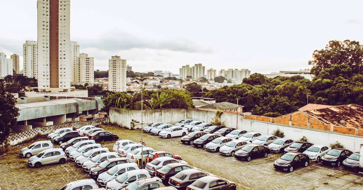 Aerial view of a crowded urban parking lot with various parked cars.