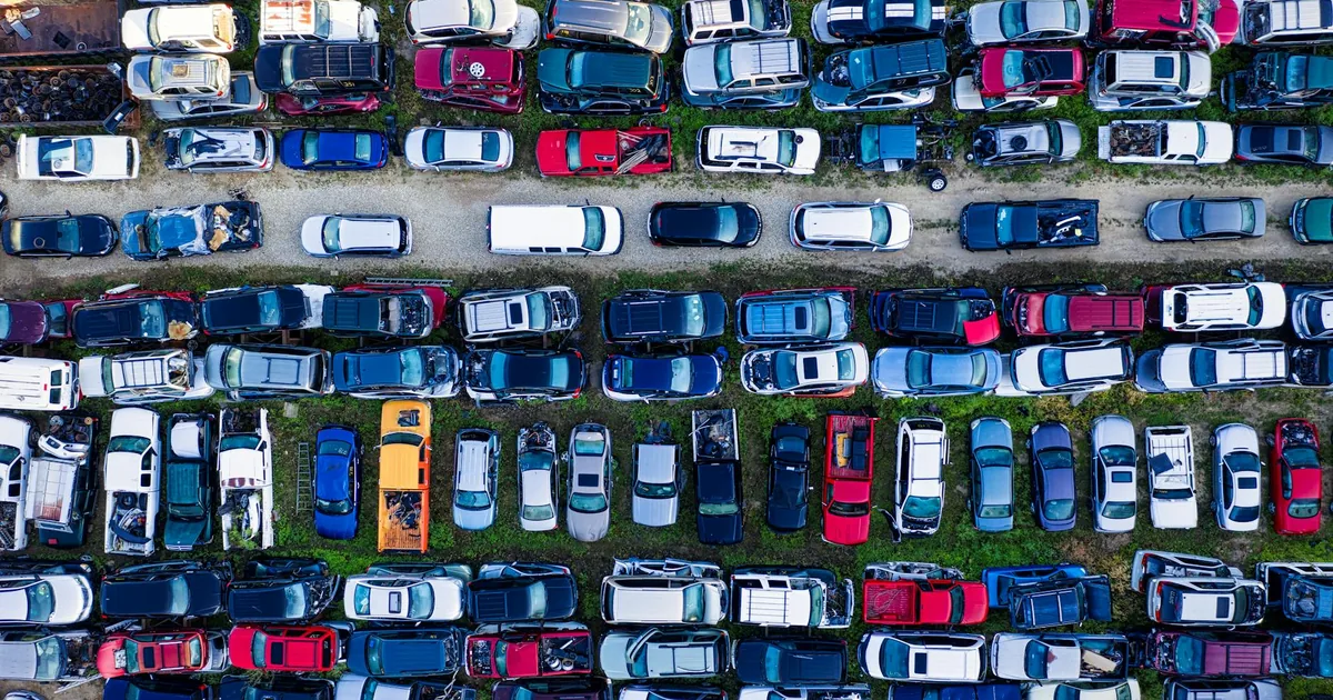 Aerial view of a densely packed parking lot with various vehicles.