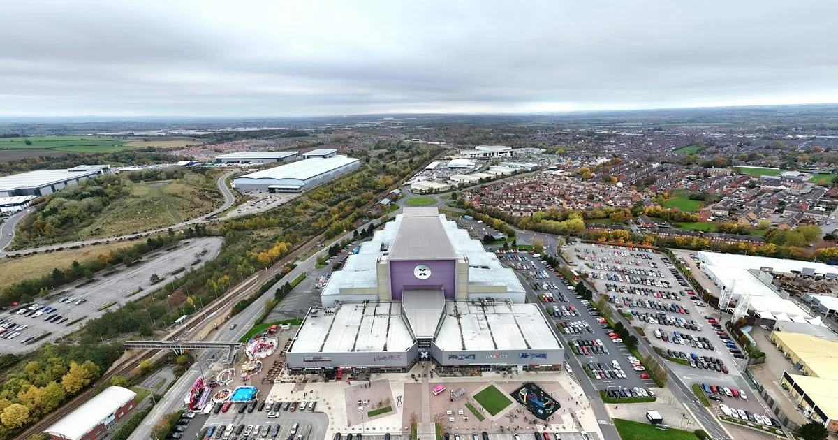 Aerial view of a large parking area filled with cars near.
