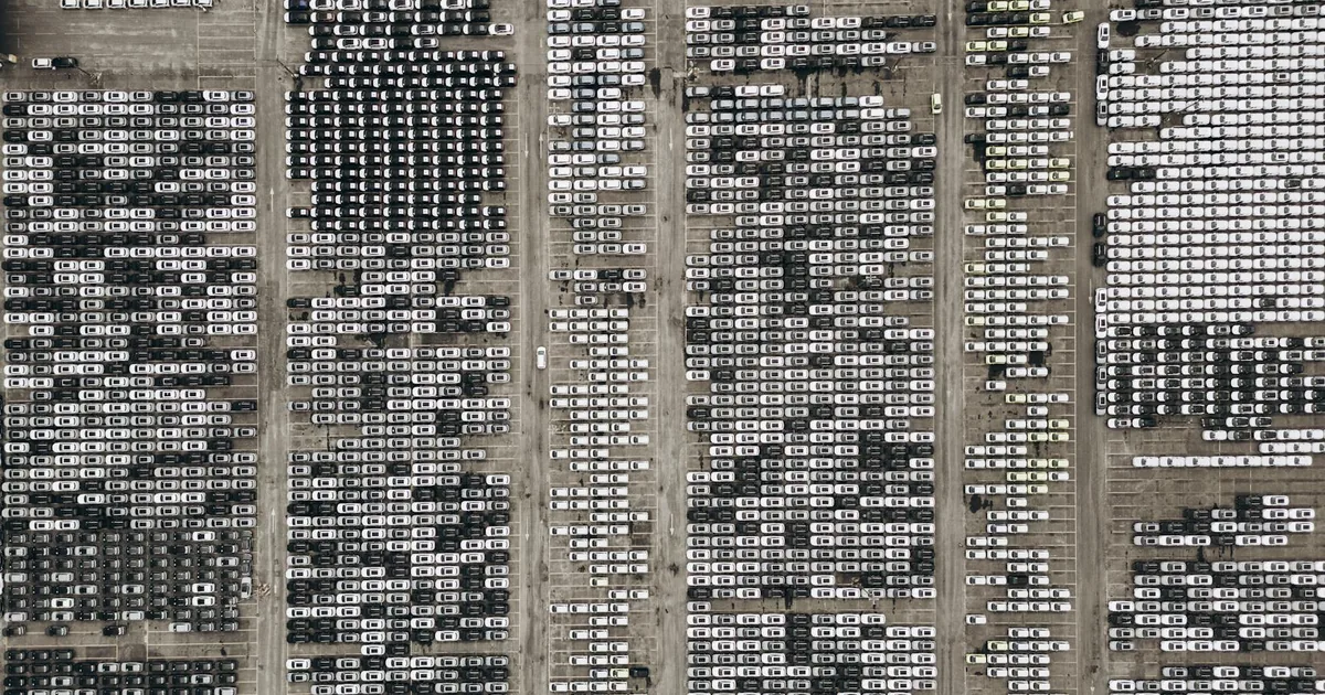 Aerial view of a large parking lot filled with numerous parked.