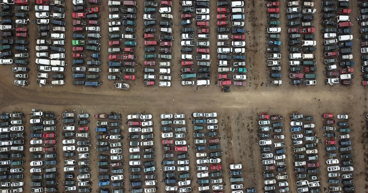 Aerial view of a large parking lot filled with various parked.