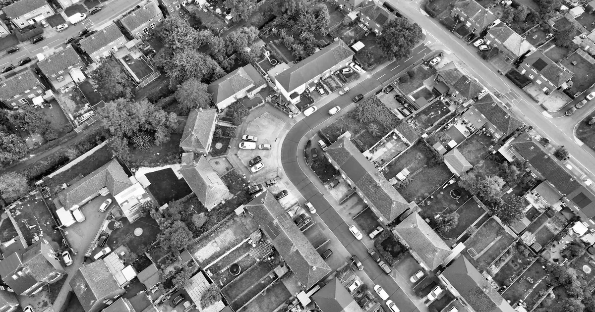 Aerial view of a neighborhood with parked cars and surrounding.