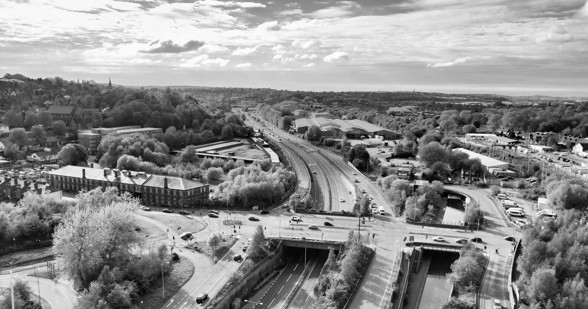 Aerial view of a parking area with vehicles and surrounding.