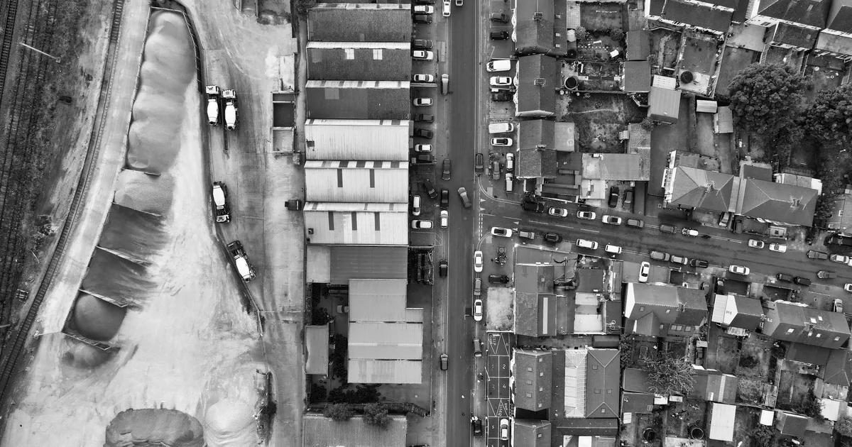 Aerial view of a parking area with vehicles and surrounding.