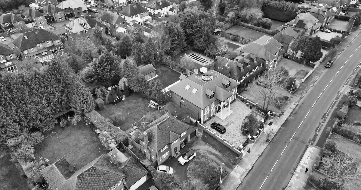 Aerial view of a residential area with parked cars and surrounding.