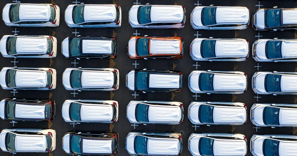 Aerial view of multiple parked cars in a parking lot with clear.