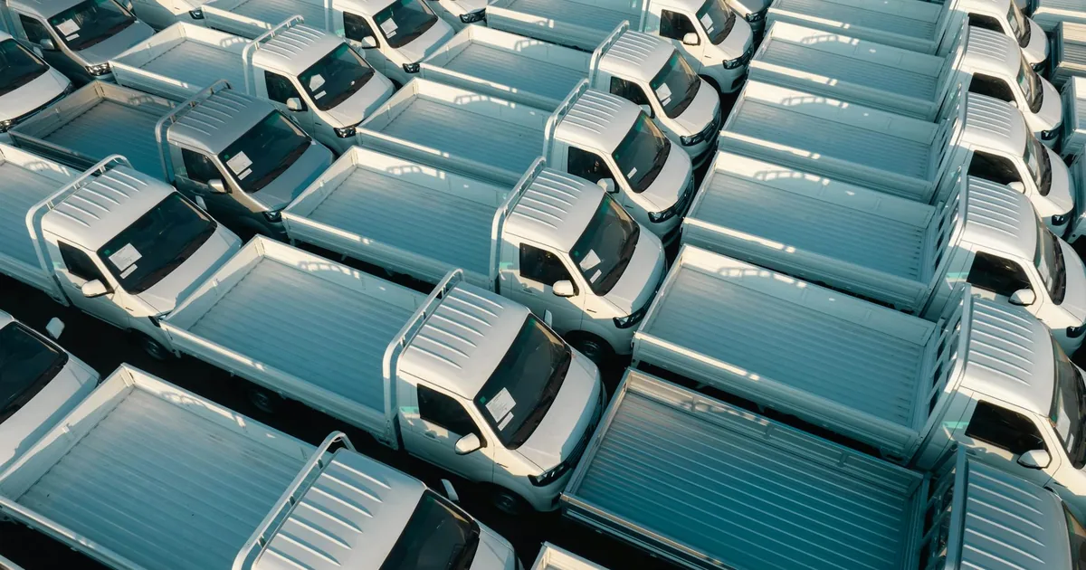 Aerial view of multiple parked trucks in a parking lot arrangement.