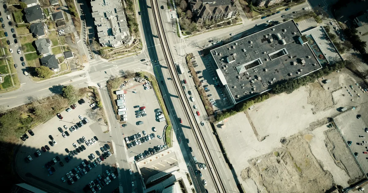 Aerial view showing a busy parking lot with various parked vehicles.