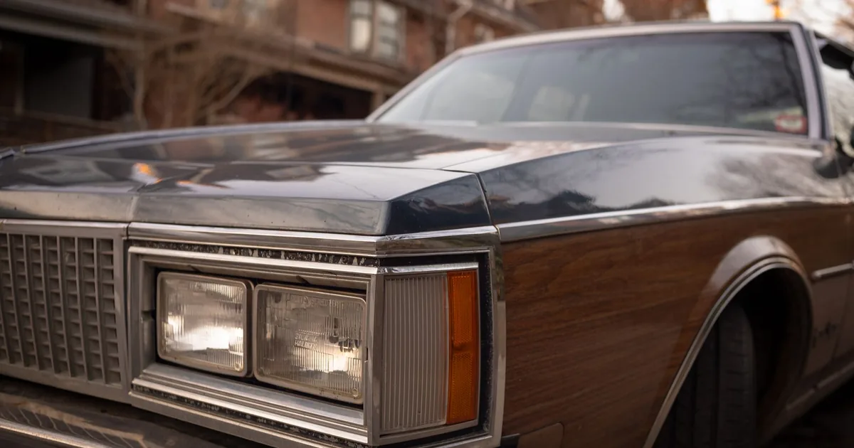 Close up view of a classic car parked on a residential street.