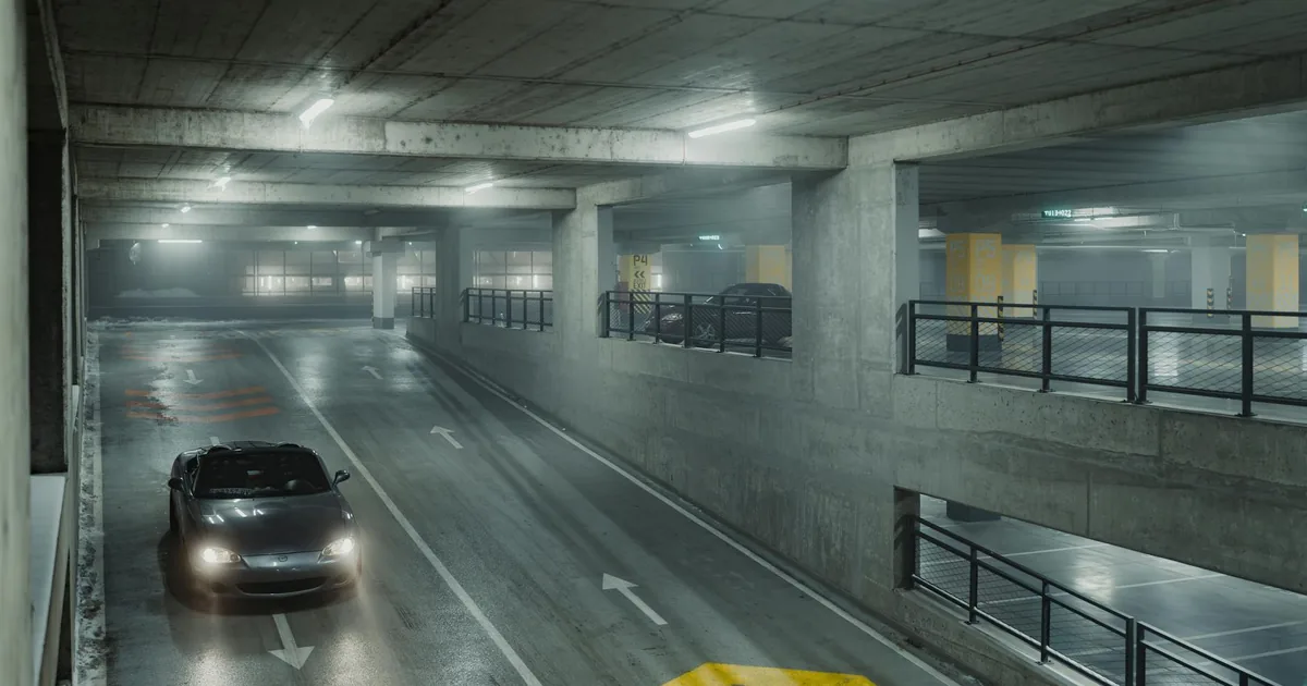 Dimly lit underground parking garage with cars and directional.