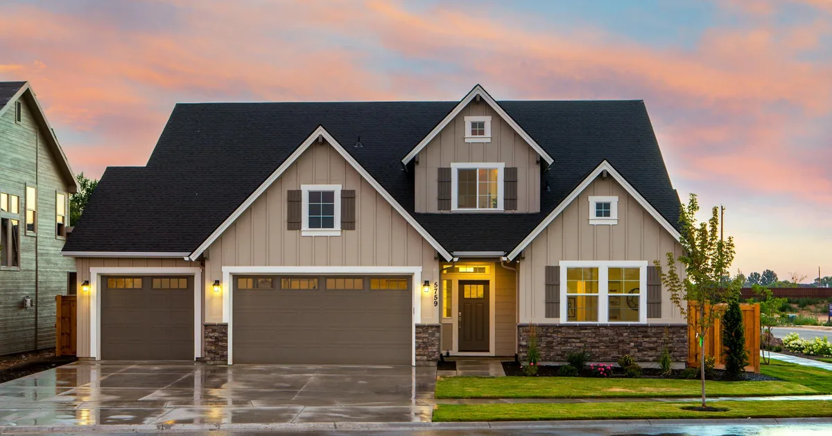Residential driveway with two garage doors and a well maintained.