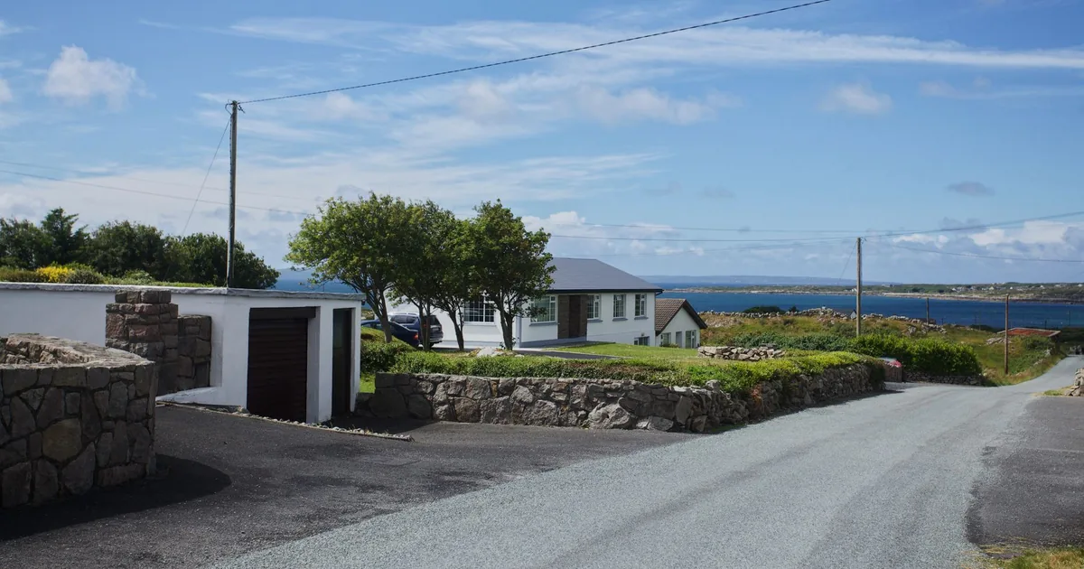 Scenic parking area near a house with a view of the ocean and.