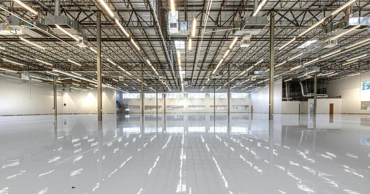 Spacious indoor parking area with polished floor and overhead.