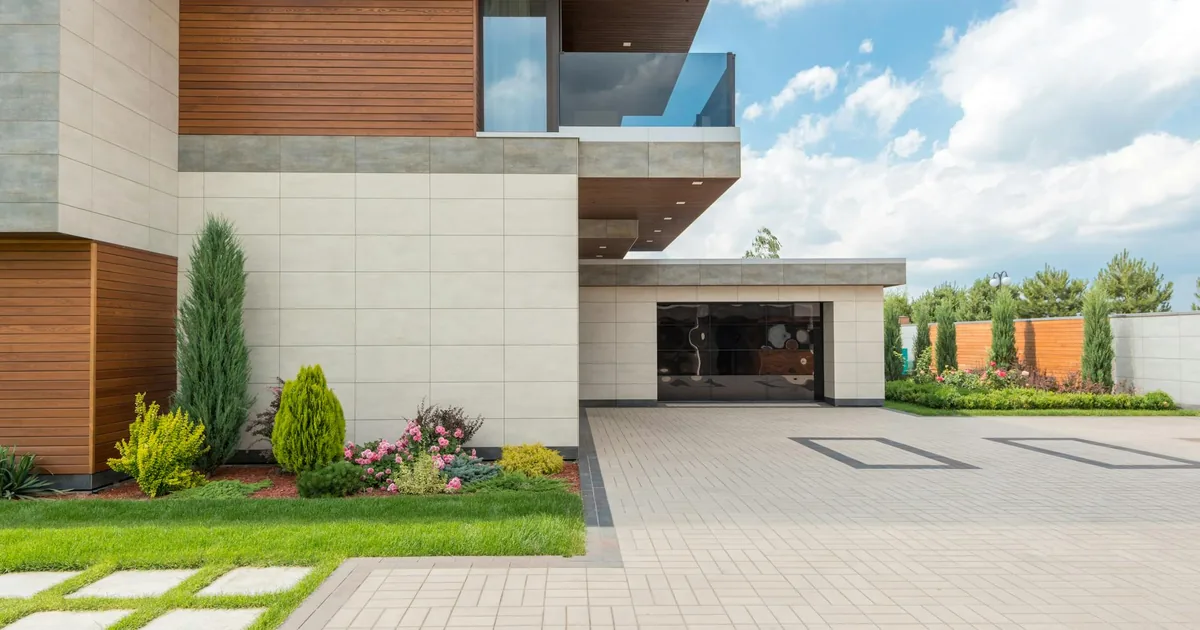 Spacious parking area in front of a modern home with landscaped.