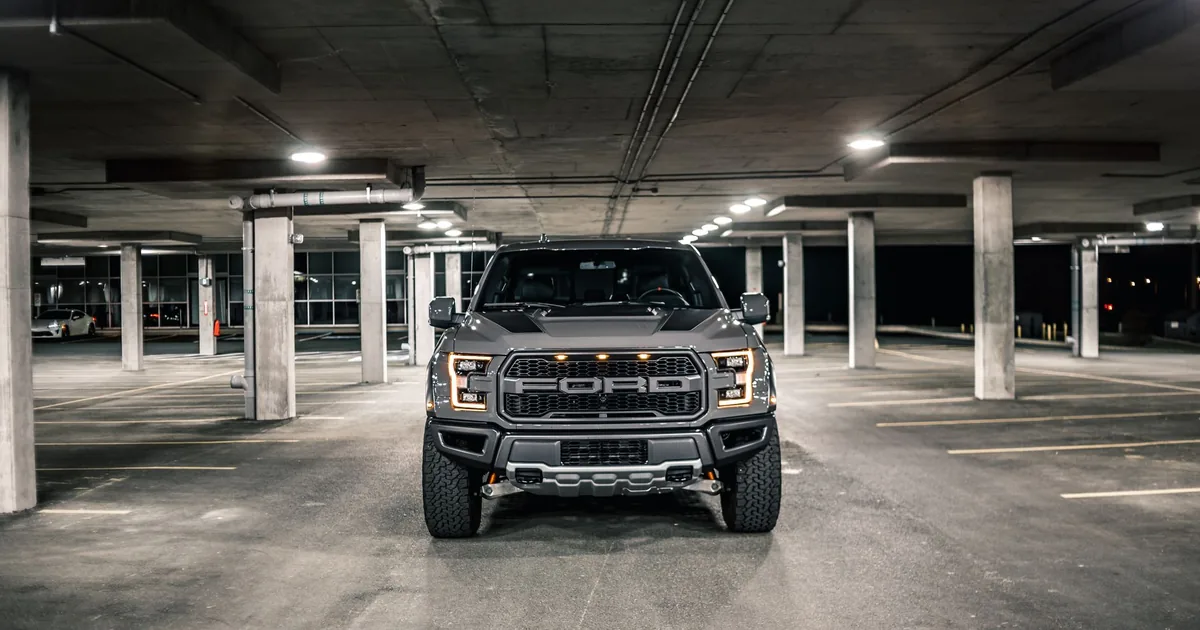 Spacious parking garage with a large vehicle parked in the center.