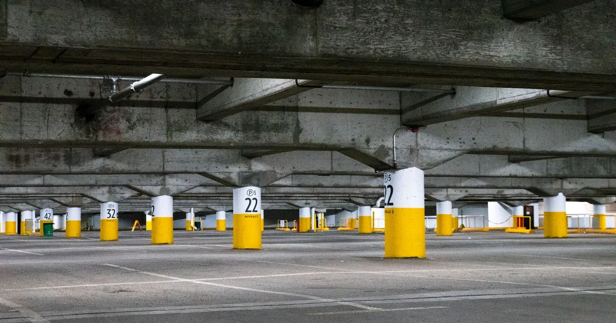 Spacious parking garage with numbered columns and empty parking.