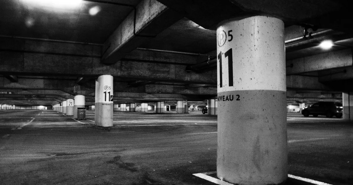 Spacious underground parking area with numbered columns and no.