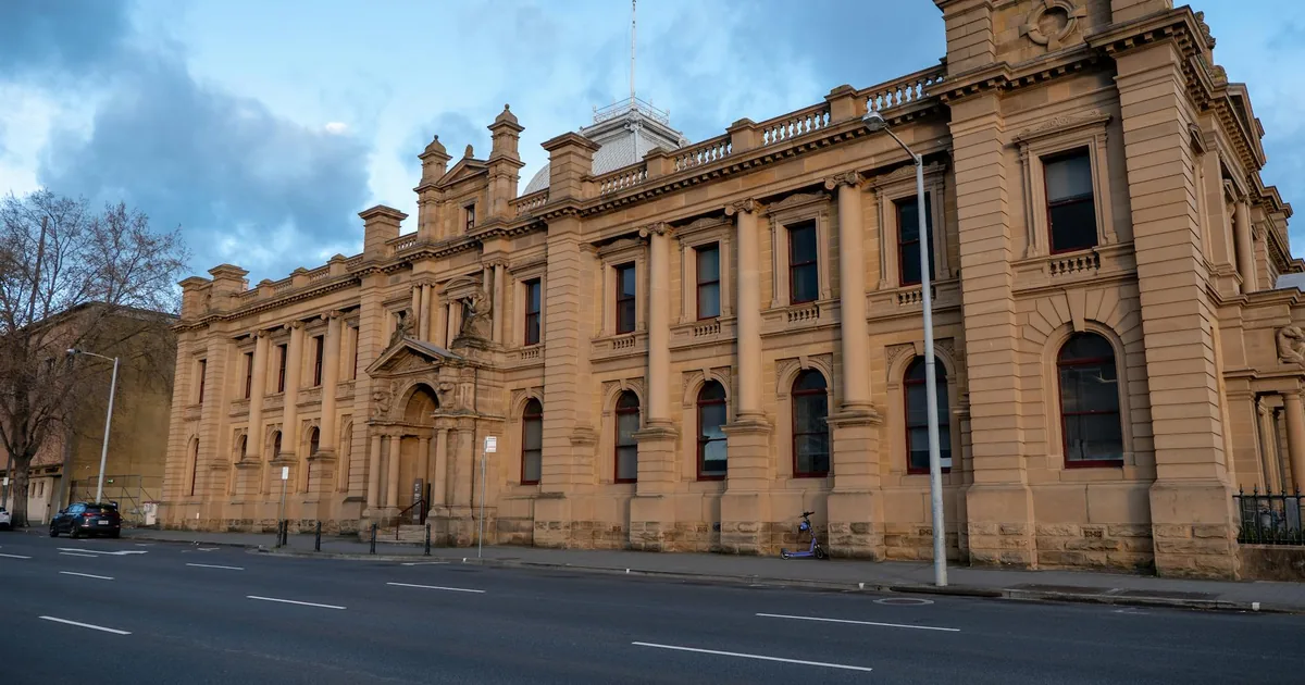 Street view of a historic building with available parking spaces.