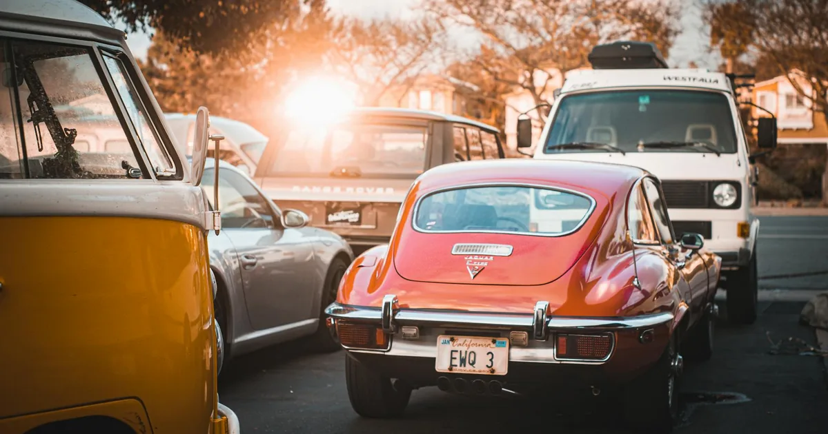 Vibrant parking scene with various cars under soft sunlight.